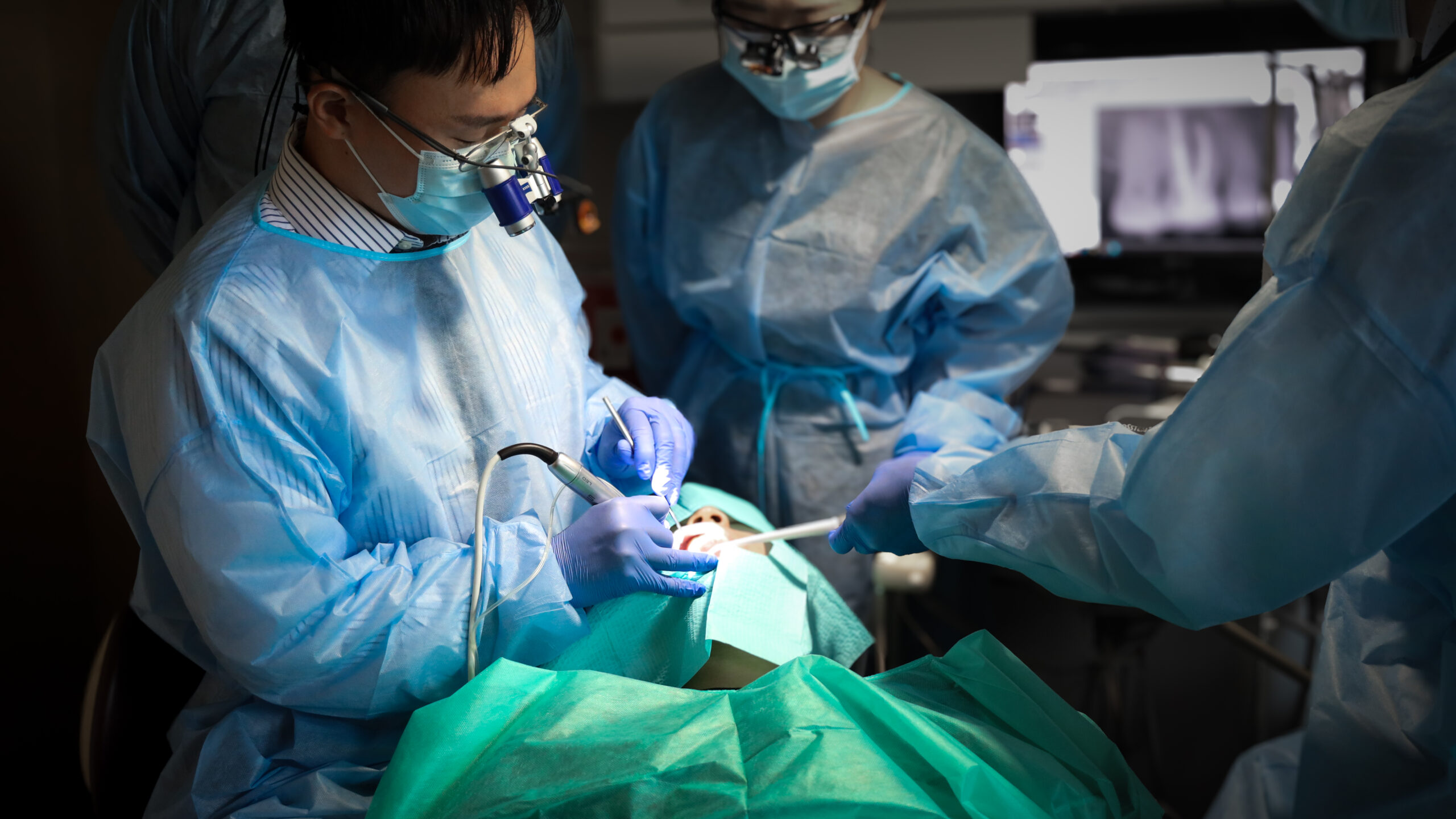 A dentist placing an implant with faculty guidance in a Think Dental Institute affiliate practice