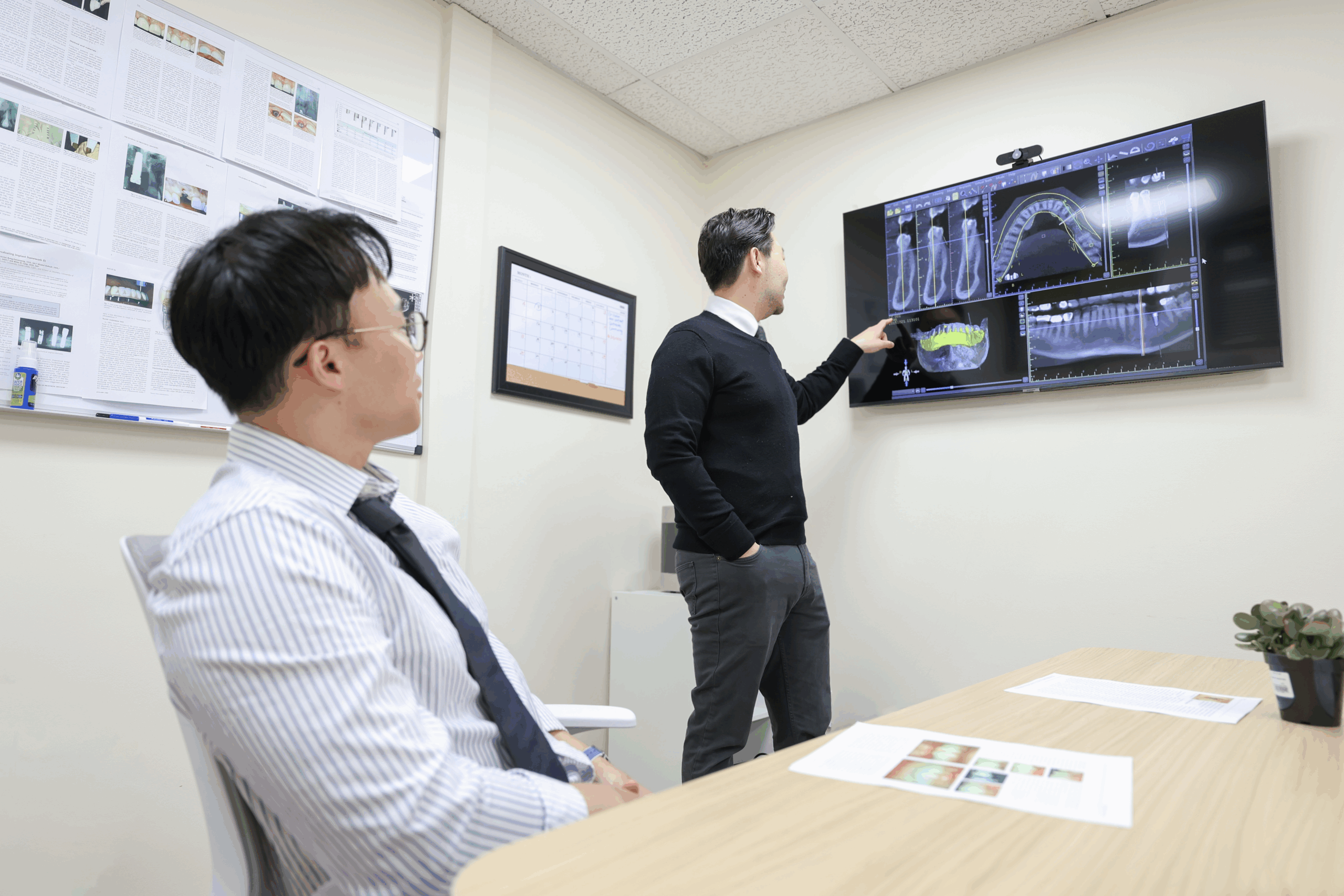 Dr. Junsoo Kwon reviewing a CBCT scan with a dentist in an affiliate practice