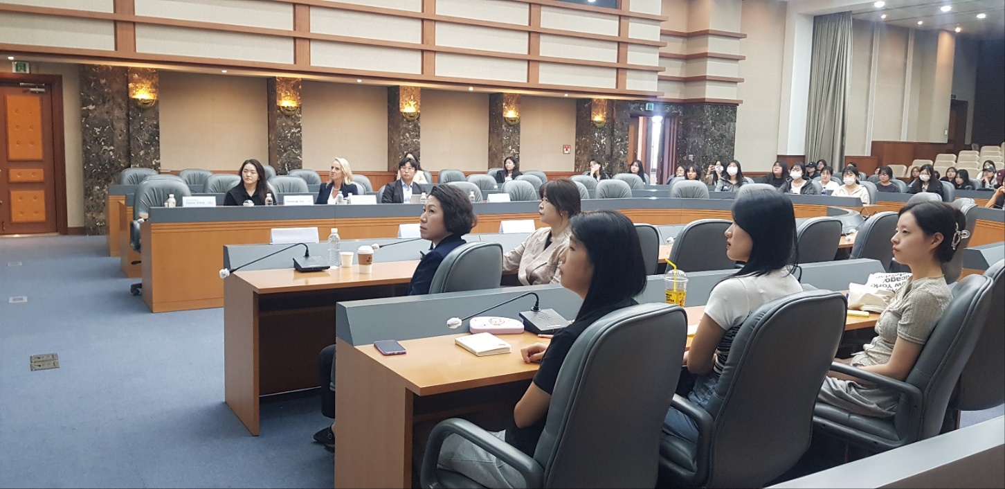 Students seated in a university lecture hall during a presentation
